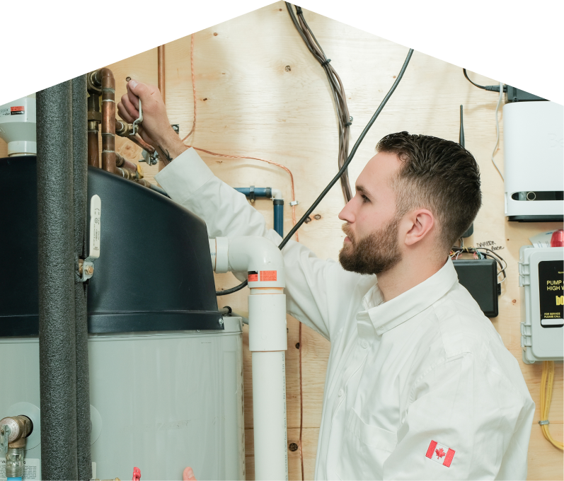 Dunn water heater specialist adjusts piping on a large residential unit during a repair service, with exposed wood paneling and mounted utility components in the background. Dunn water heater specialist adjusts piping on a large residential unit during a repair service, with exposed wood paneling and mounted utility components in the background.