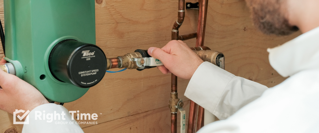 HVAC technician inspecting side piping on a home boiler system in Waterloo.