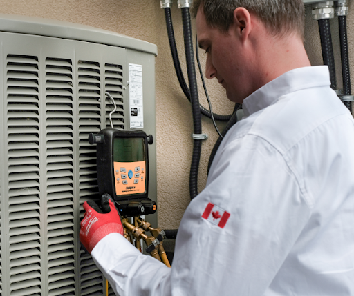 Dunn Heating technician diagnosing refrigerant pressure on an outdoor AC condenser during an emergency service call.